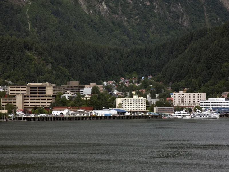 Downtown Juneau along Gastineau Channel, below steep forested mountains.