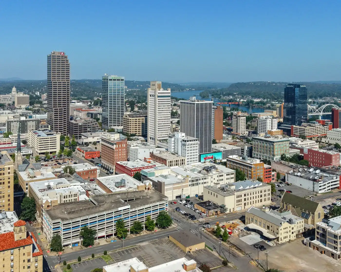 Downtown Little Rock’s towers from above, with the Arkansas River and its bridges beyond.