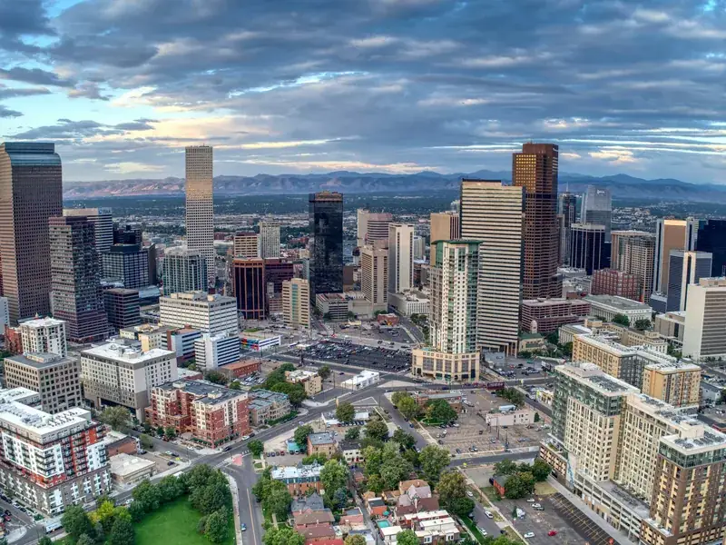 Downtown Denver from the air, with the Rocky Mountains on the horizon.