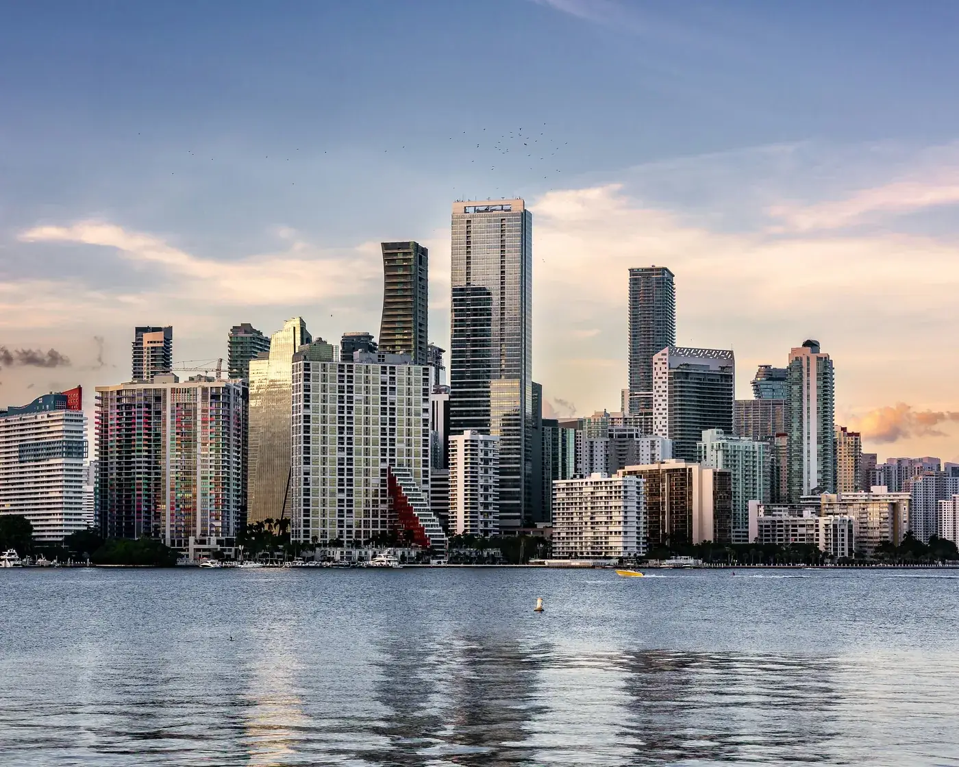 Miami’s Brickell skyline across Biscayne Bay in late-afternoon light.