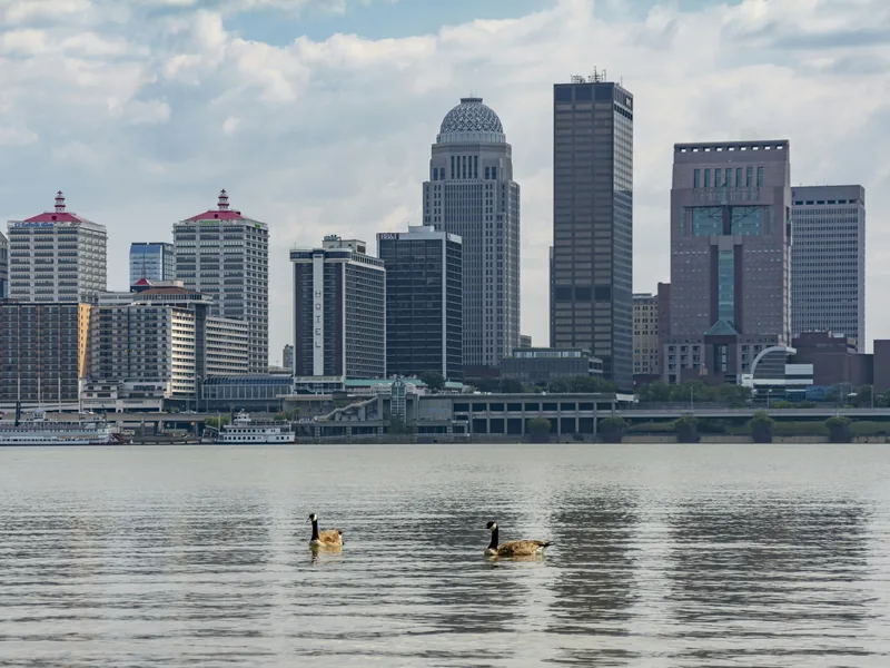 Downtown Louisville’s skyline across the Ohio River on a bright day.