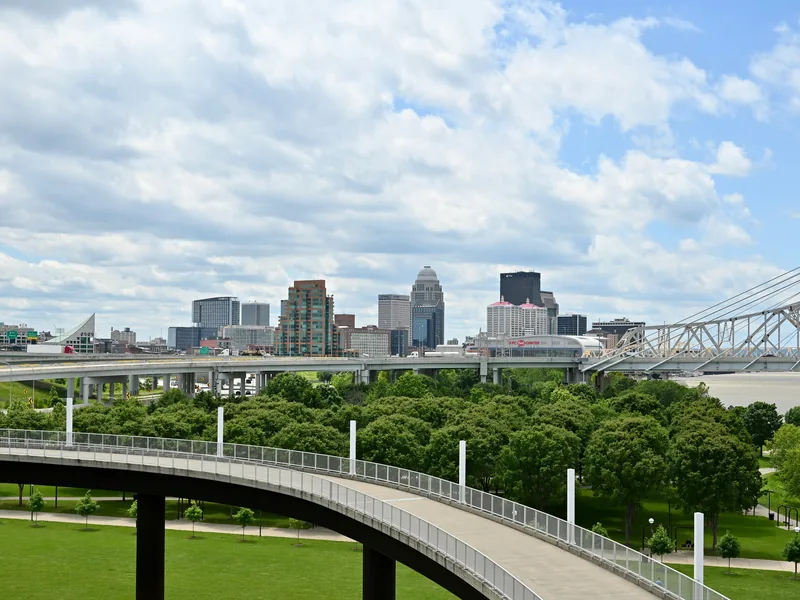 Downtown Louisville’s skyline beyond Waterfront Park and the Big Four Bridge ramp.