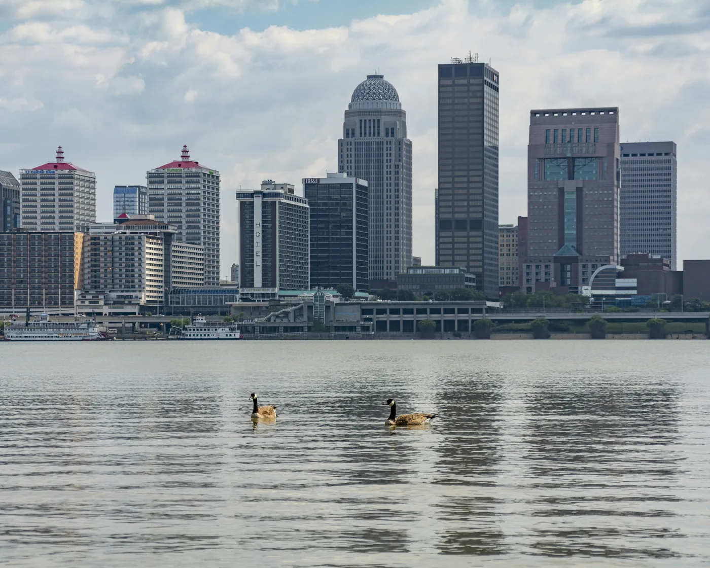 Downtown Louisville’s skyline across the Ohio River on a bright day.