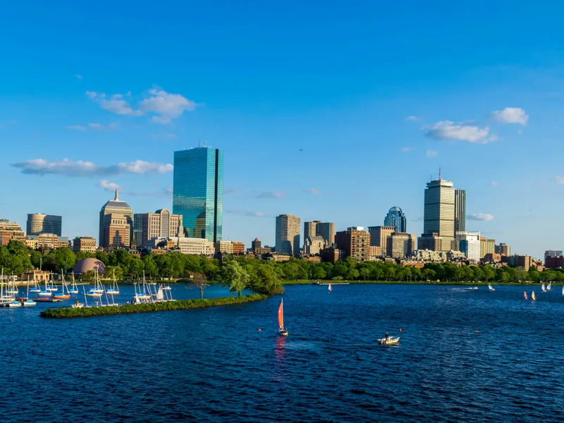 Boston’s Back Bay skyline and sailboats on the Charles River on a clear afternoon, seen from Cambridge.