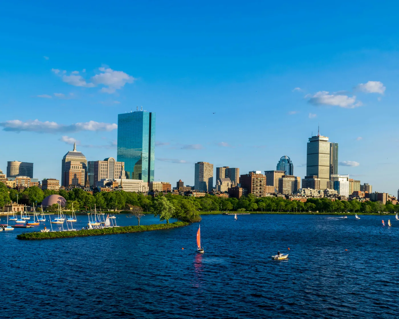Boston’s Back Bay skyline and sailboats on the Charles River on a clear afternoon, seen from Cambridge.