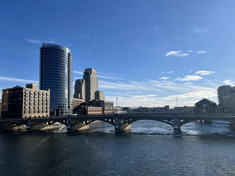 Downtown Grand Rapids and a bridge over the Grand River on a clear day.