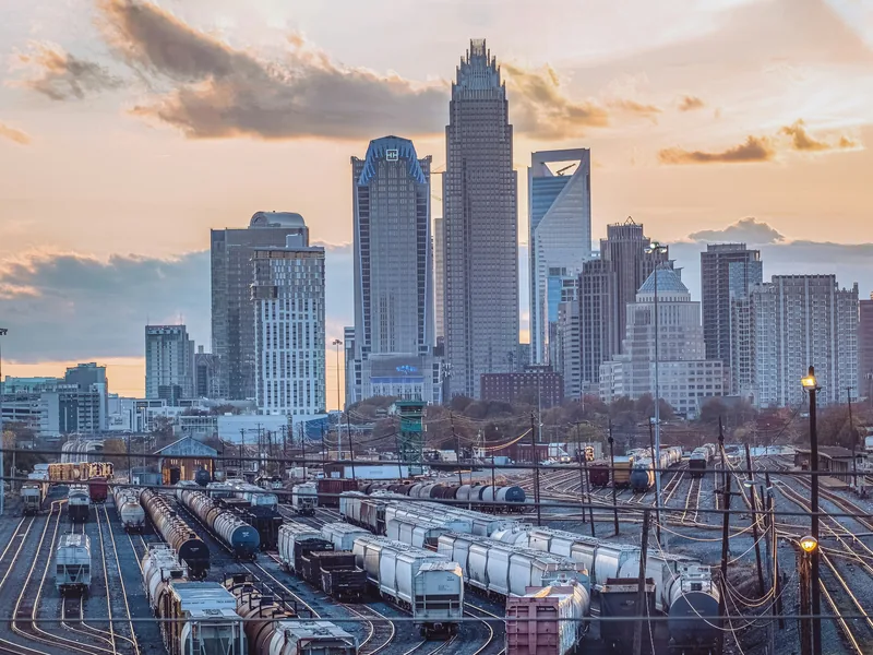 Uptown Charlotte’s skyline at sunset above the rail yard on the edge of the city center.