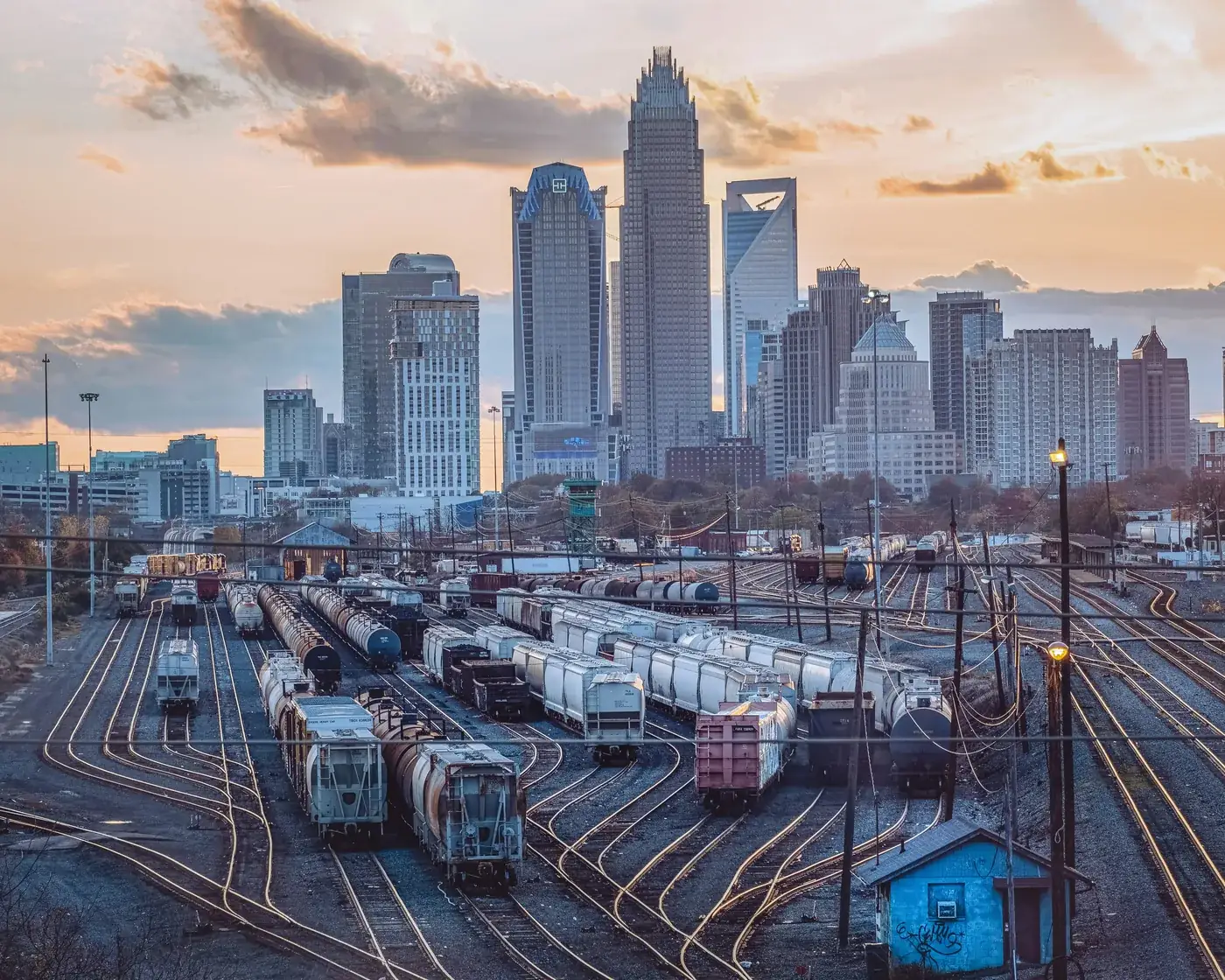 Uptown Charlotte’s skyline at sunset above the rail yard on the edge of the city center.