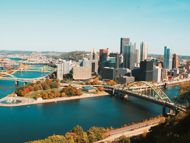 Downtown Pittsburgh and Point State Park where the rivers meet, in autumn color, seen from the hills to the south.