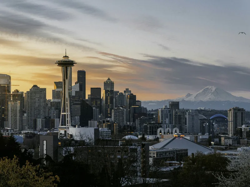 The Space Needle and downtown Seattle under a golden sky, with Mount Rainier on the horizon, from Kerry Park.