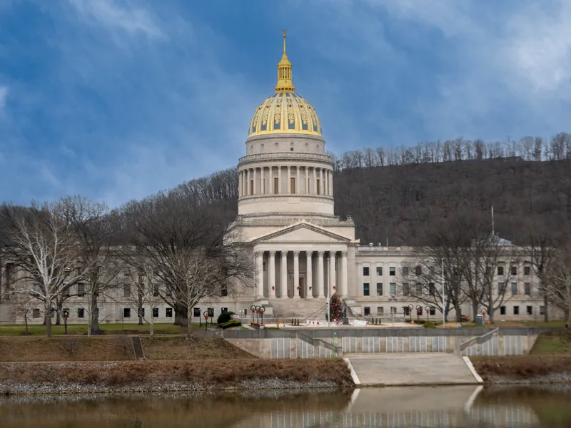 The gold dome of the West Virginia State Capitol in Charleston, seen across the Kanawha River in winter.