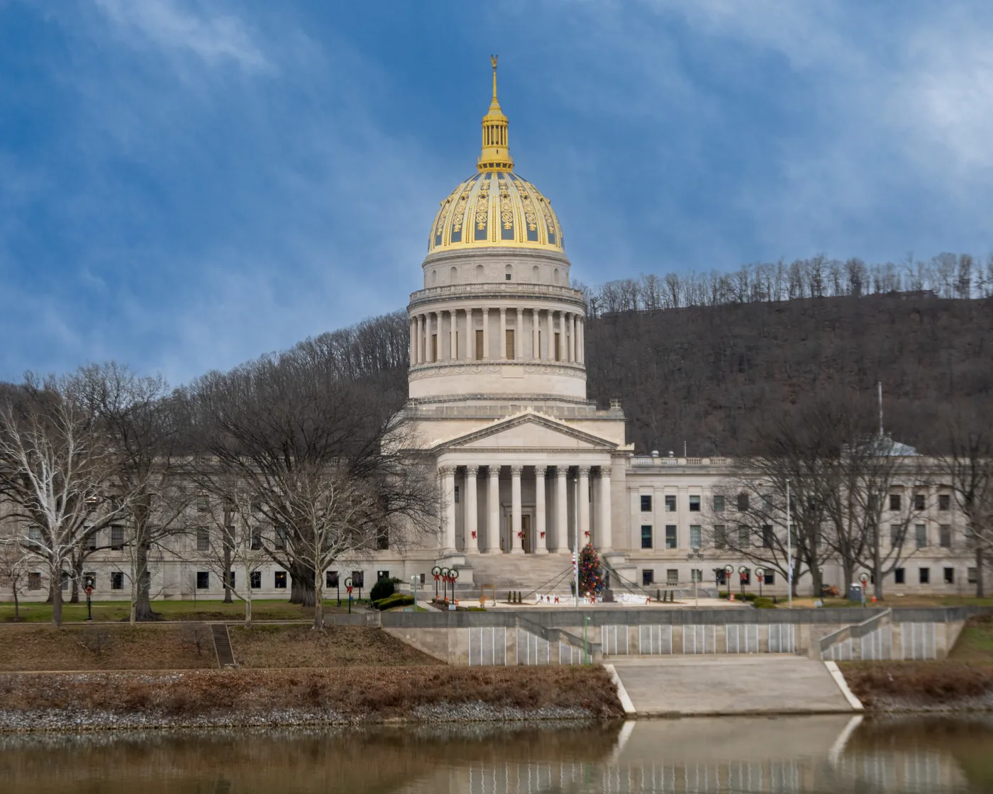 The gold dome of the West Virginia State Capitol in Charleston, seen across the Kanawha River in winter.