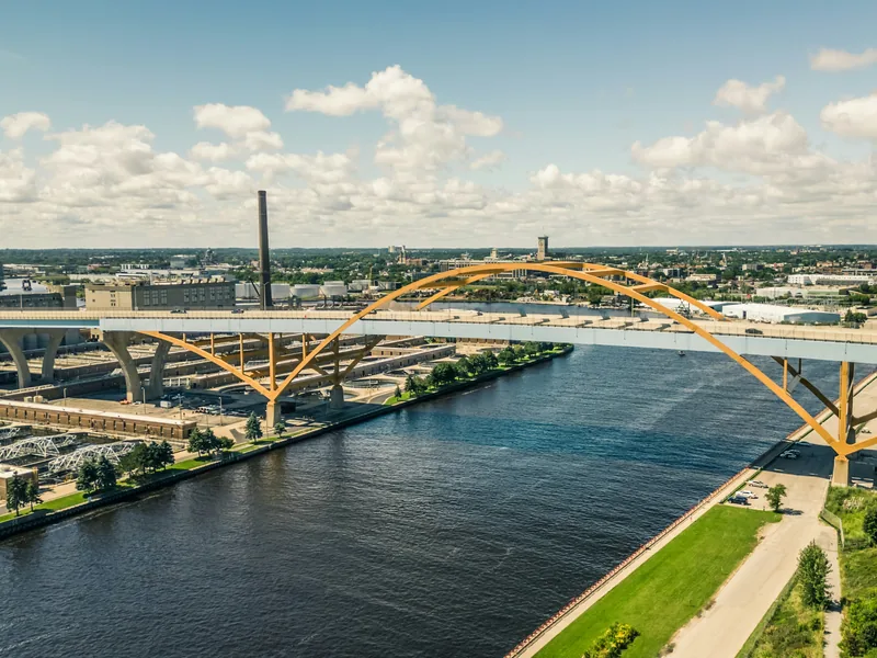 An aerial view of the yellow arches of the Hoan Bridge crossing the Milwaukee River in Milwaukee.