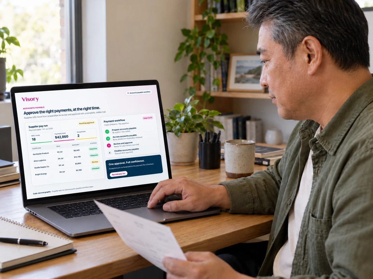 A business owner reviews vendor payments in the Visory accounts payable workflow on a laptop.